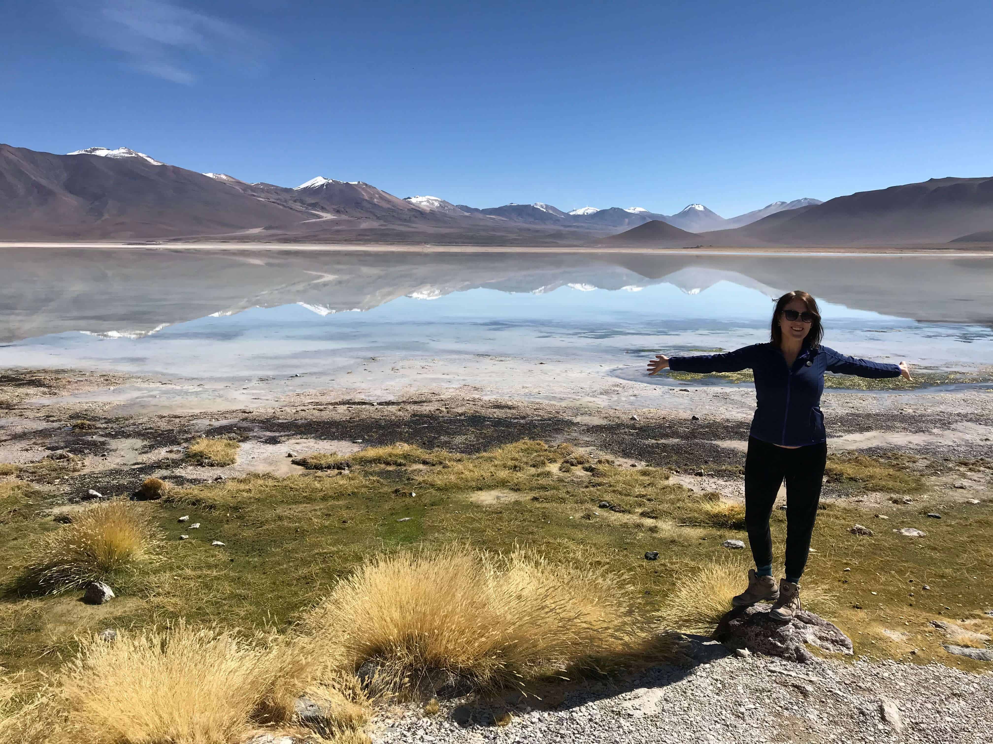 lora standing in front of Reflecting mountains and lakes in Bolivia