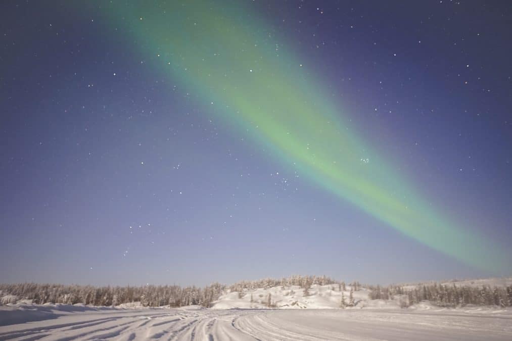 aurora borealis above an ice road