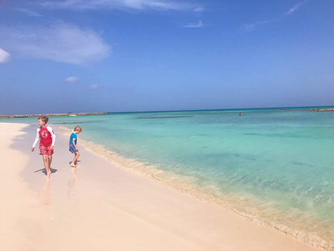family walking on beach in Aruba