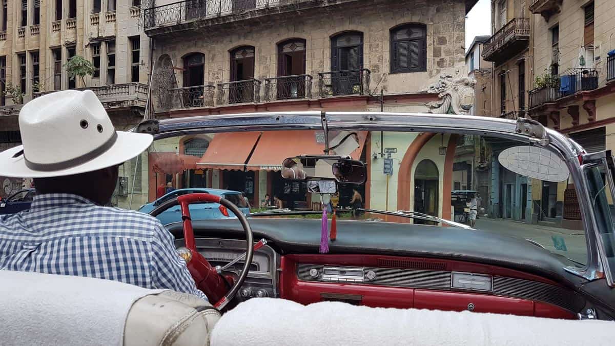 man driving car in cuba