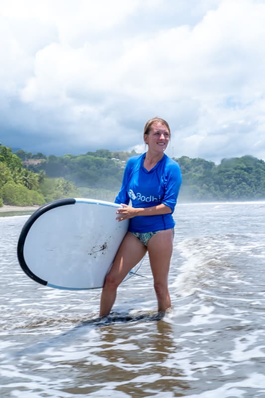 girl holding surf board uvita costa rica