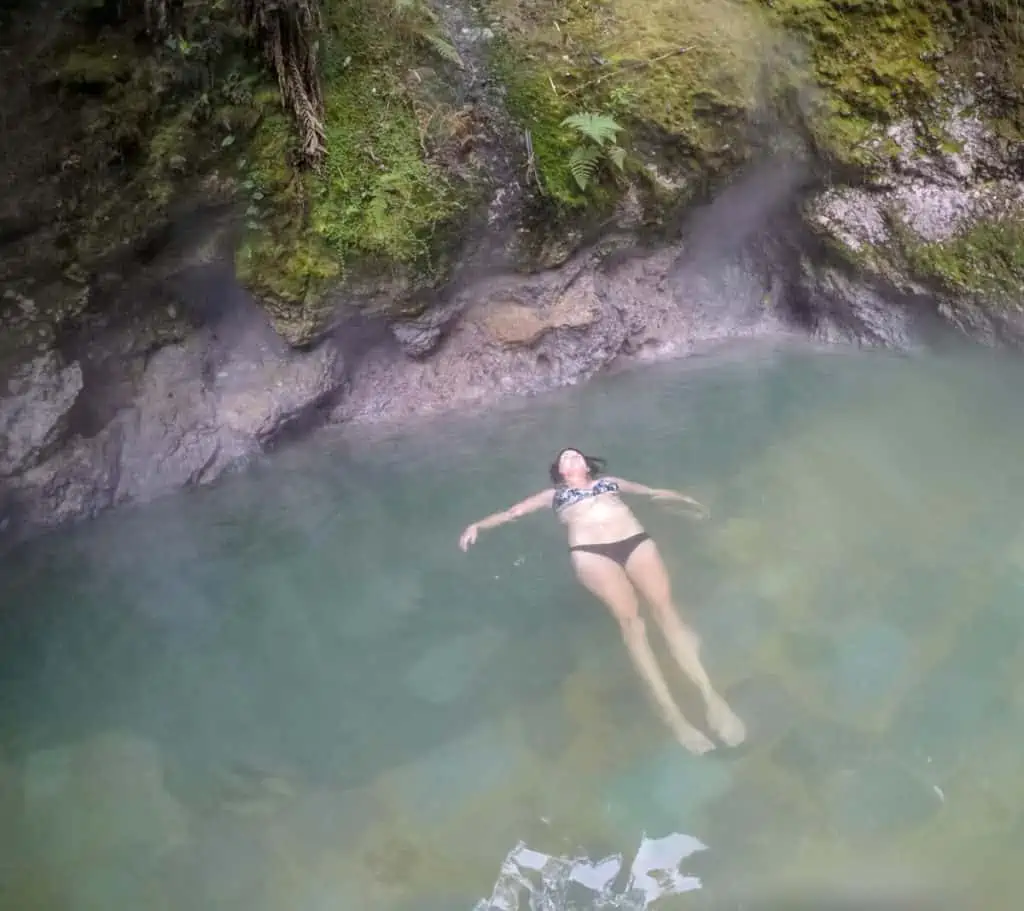 lora relaxing at fuentes georginas hot springs guatemala