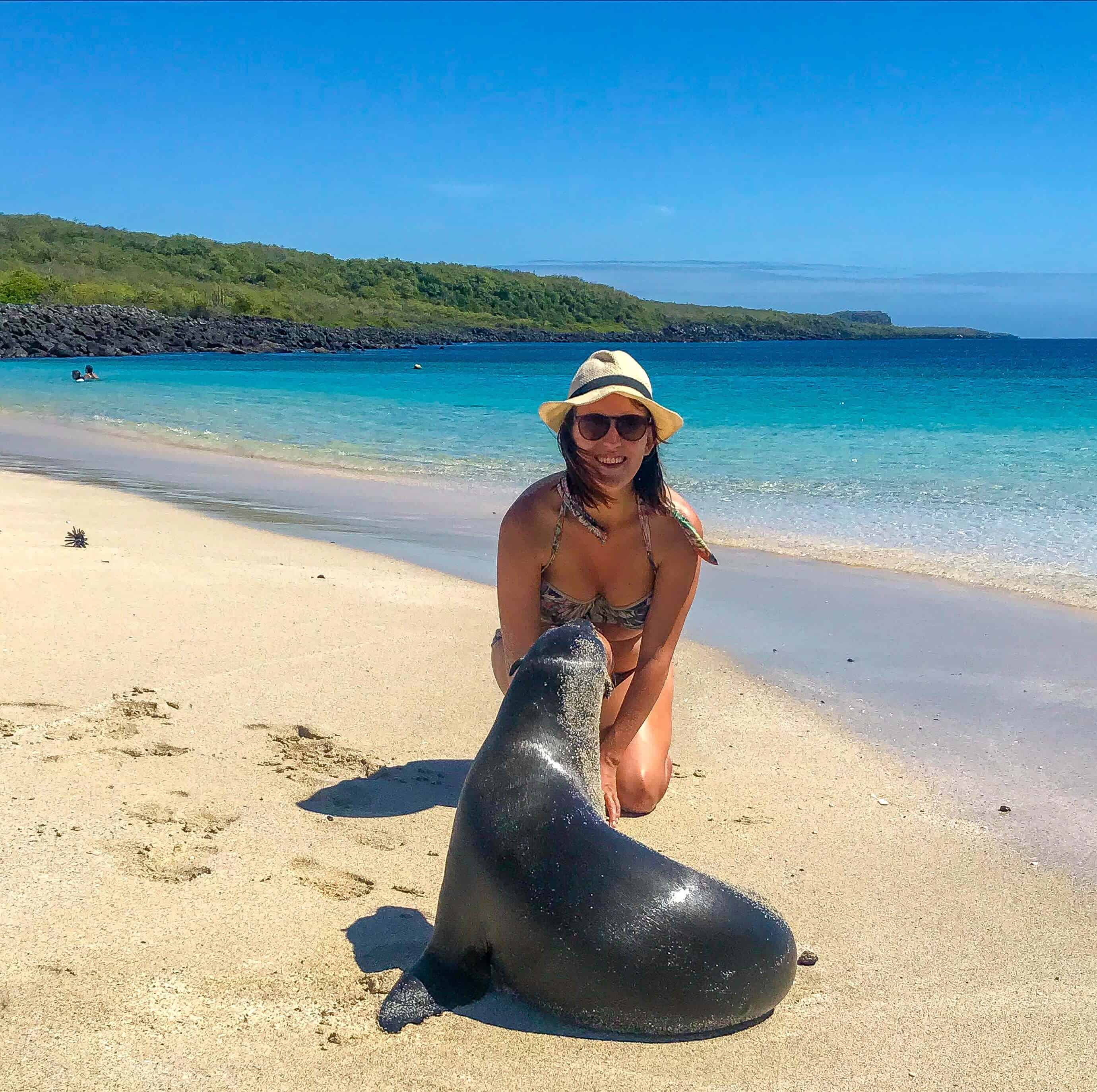 Lora with sea lions on beach in San Cristobal