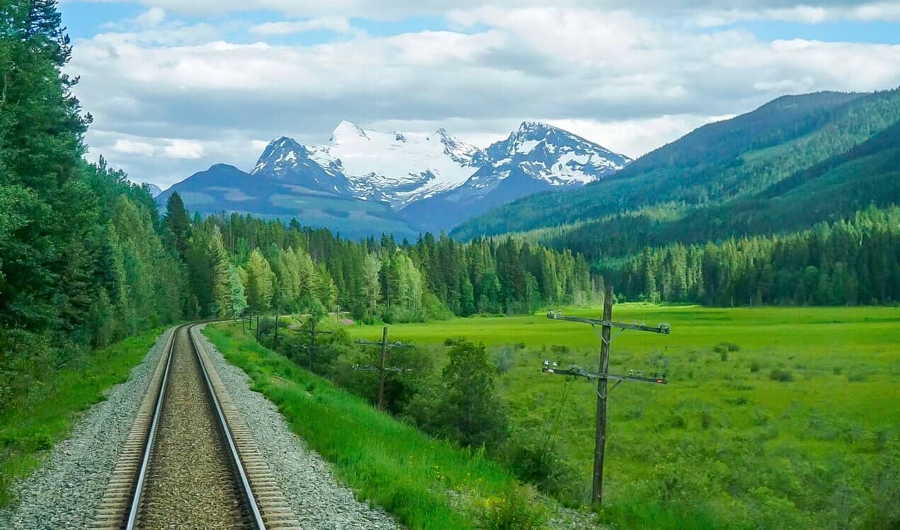 views of the rocky mountains from back of via rail train across canada