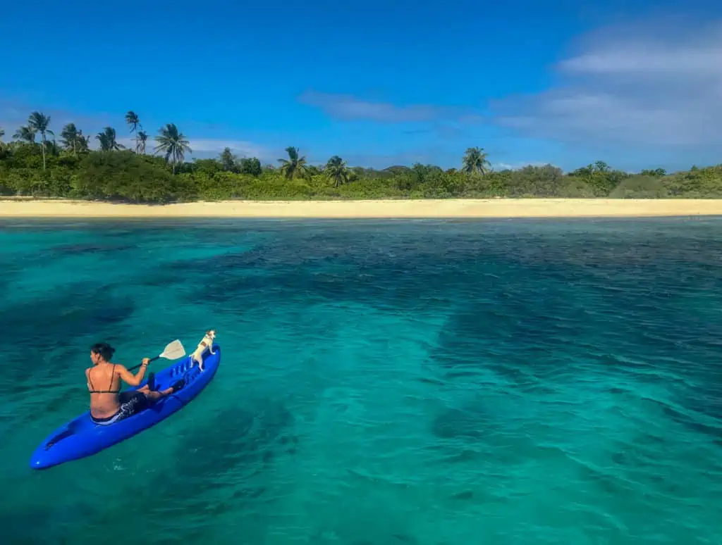 girl Kayaking with a dog in the Philippines 