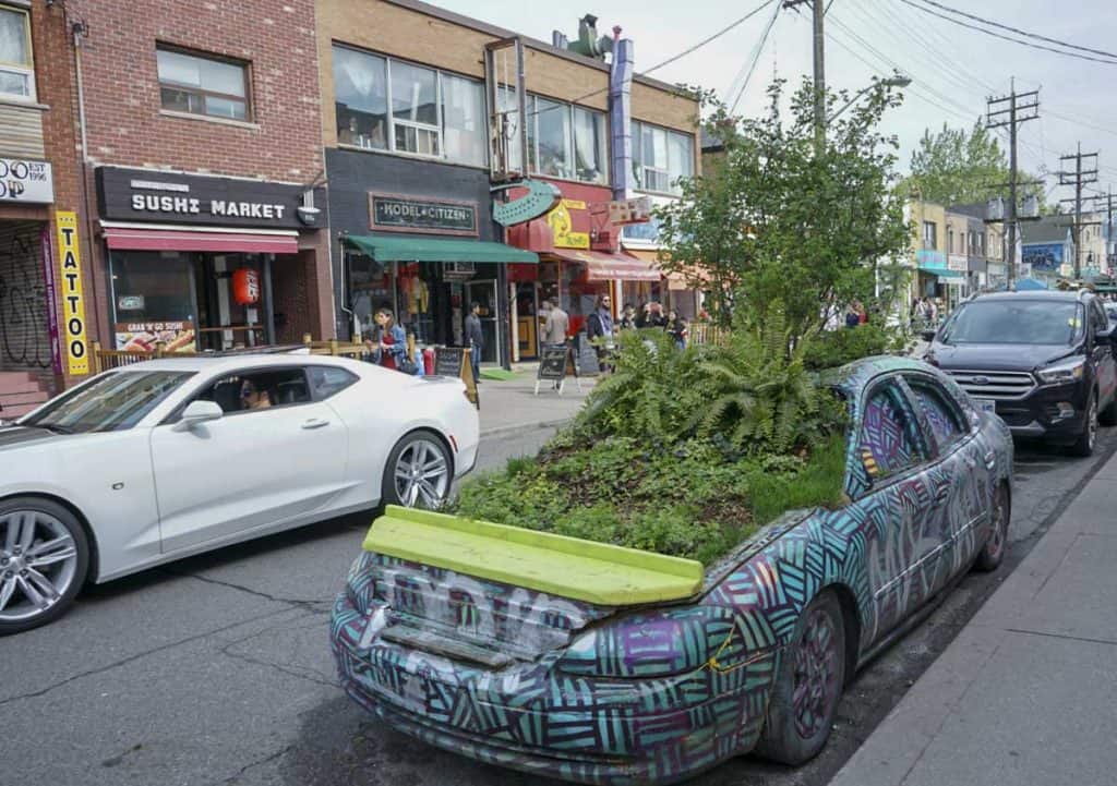car with plant in Kensington Market in Toronto