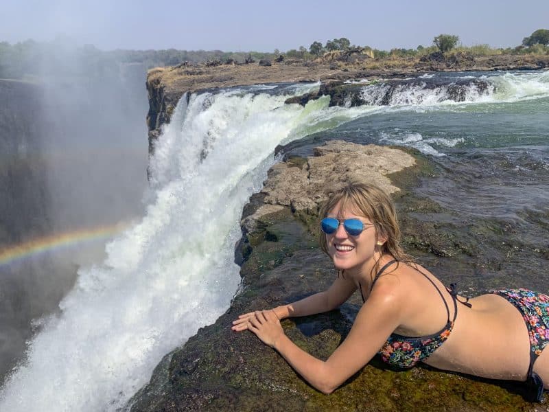 girl on top of devil's pool zambia africa