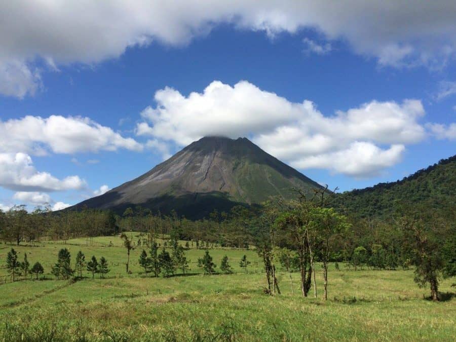 Arenal Volcano with clouds over it hiking la fortuna