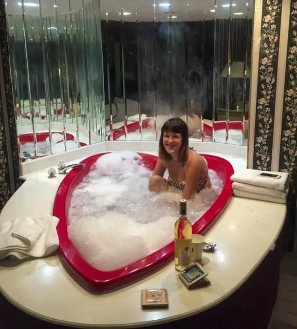 girl in heart shaped hot tub