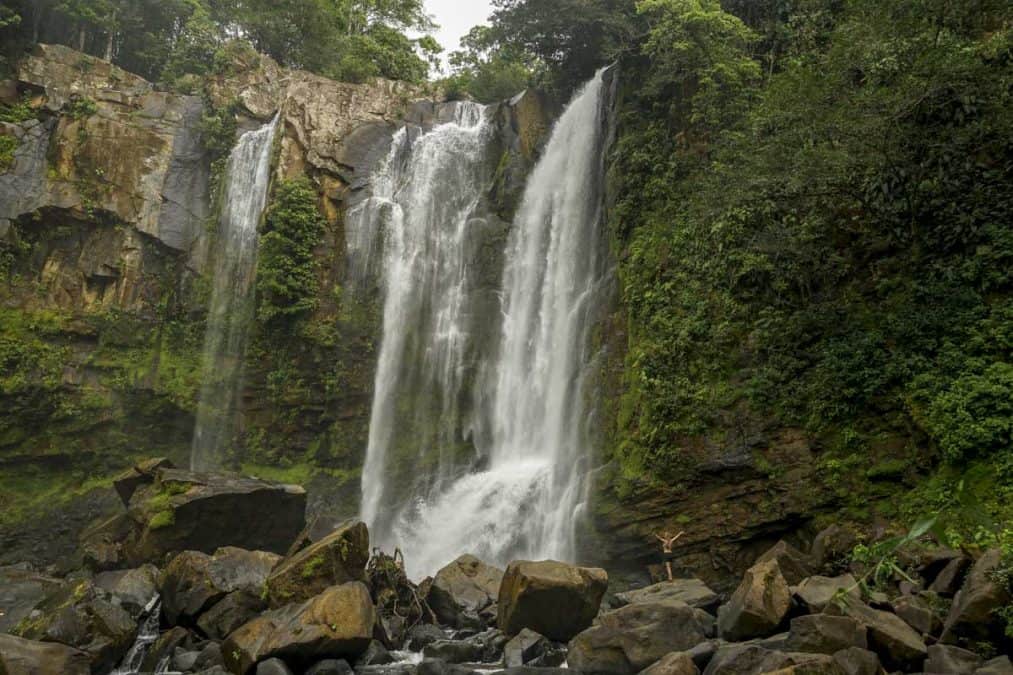 lora standing under nauyaca waterfalls