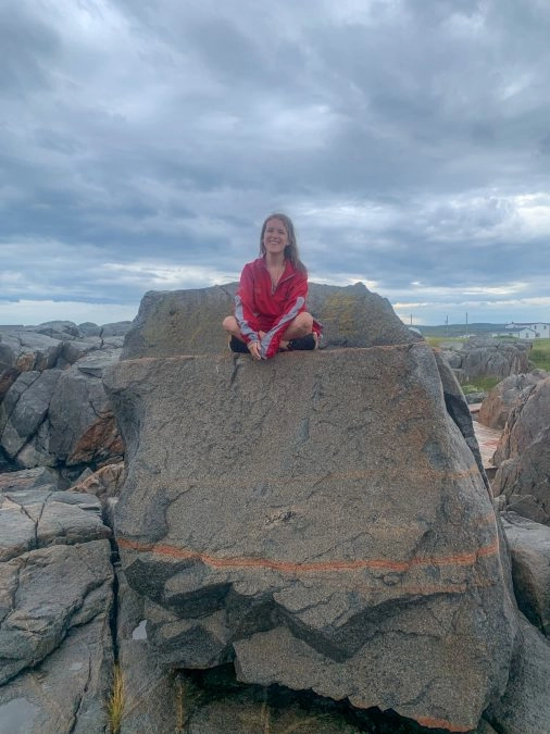 lora sitting on the devil's rocking chair fogo newfoundland