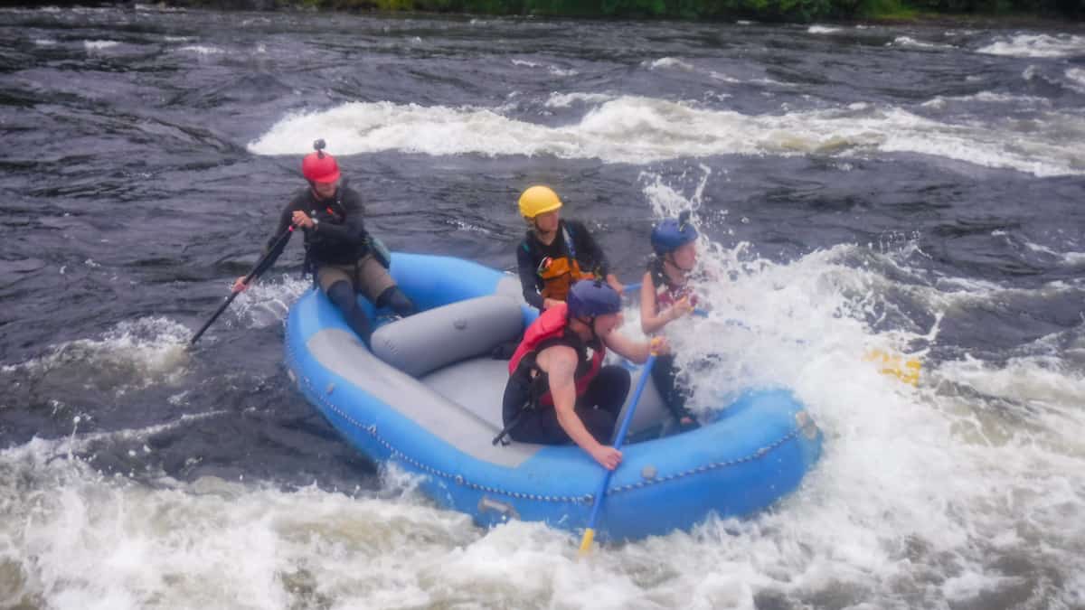 four people on a river raft in newfoundland