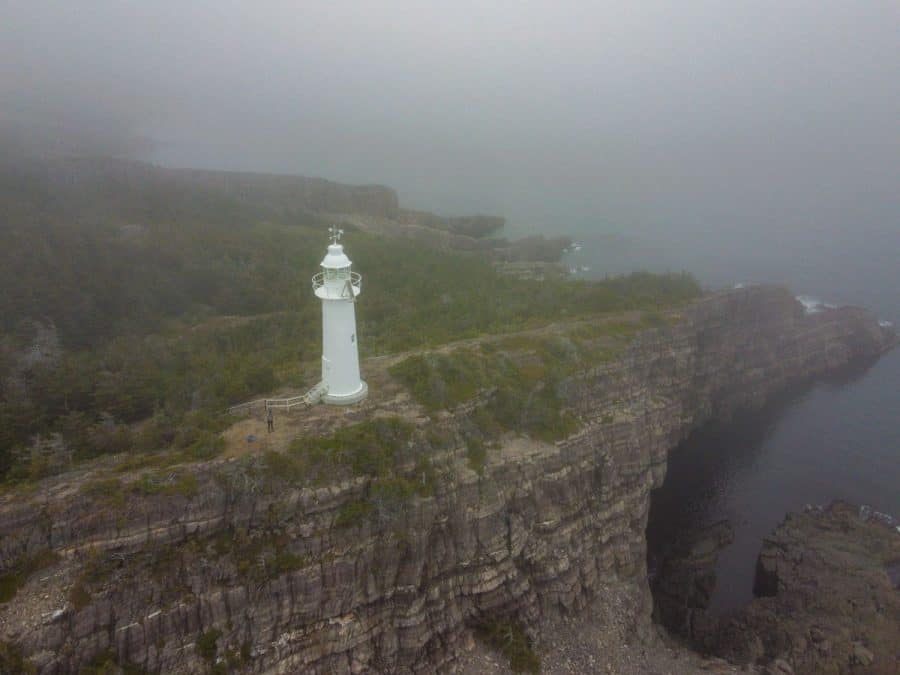 white lighthouse in the fog newfoundland