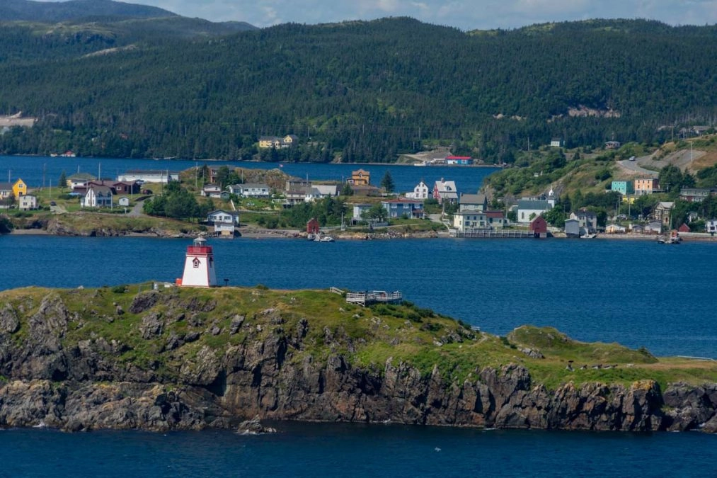 view of colorful houses by atlantic ocean on the skerwink trail