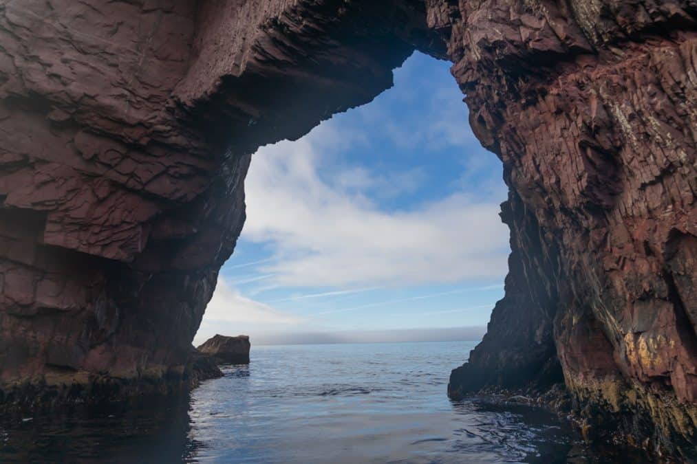 view of Tickle Cove Sea Arch over the ocean in newfoundland