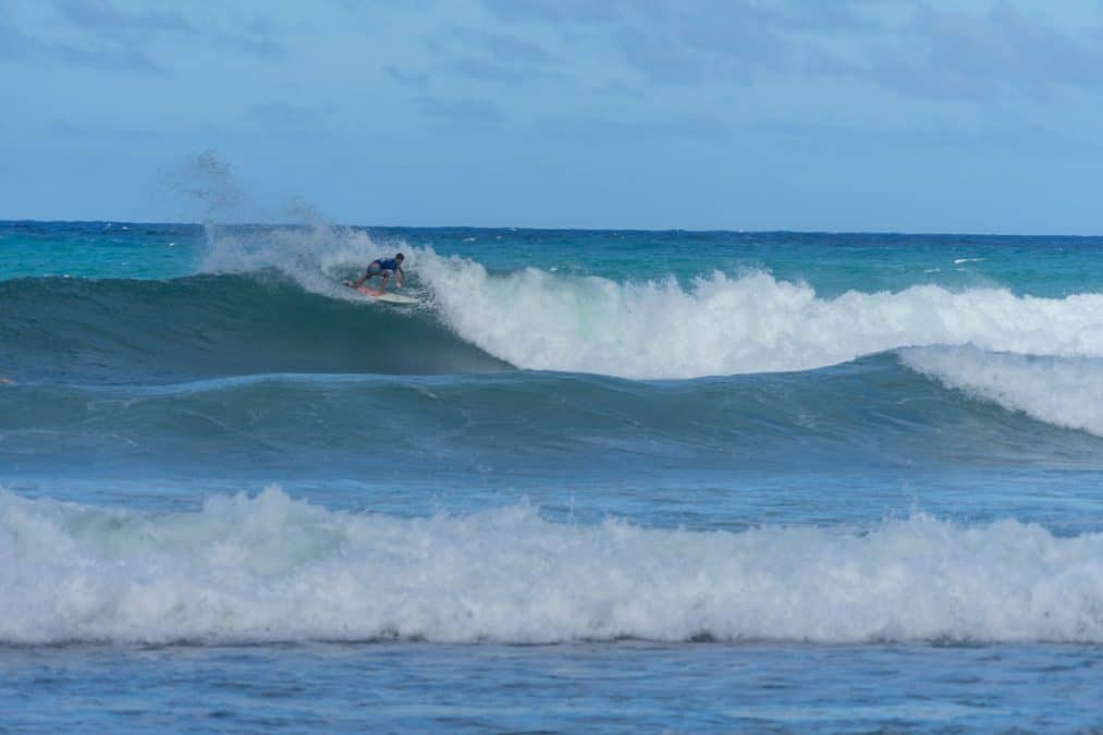 a man surfing on a big waves on the atlantic coast in bathsheba barbados