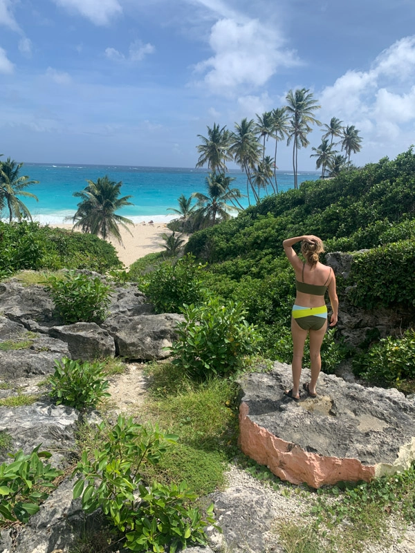 girl looking at turquoise ocean in barbados