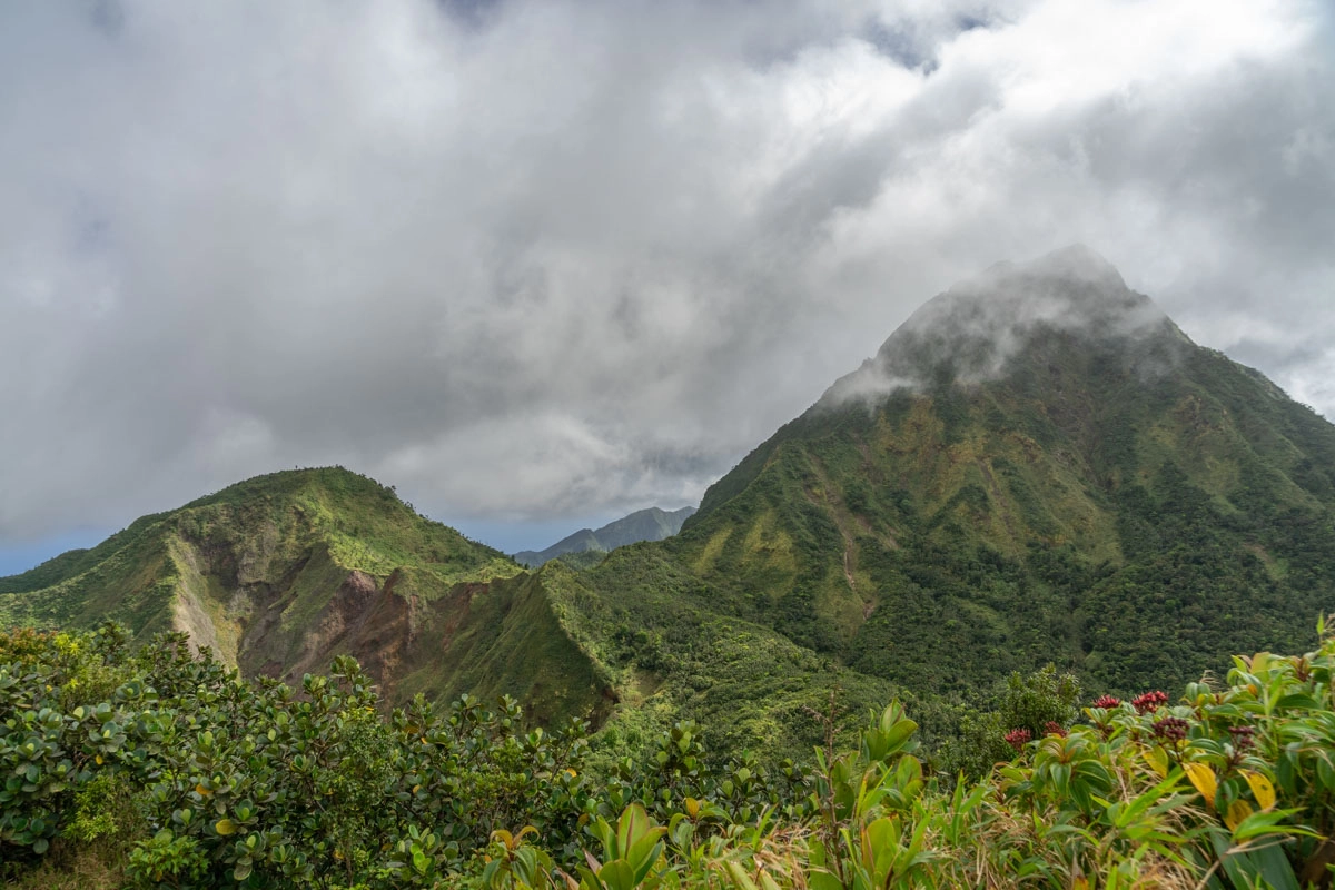 mountain landscapes in dominica with clouds rolling over them