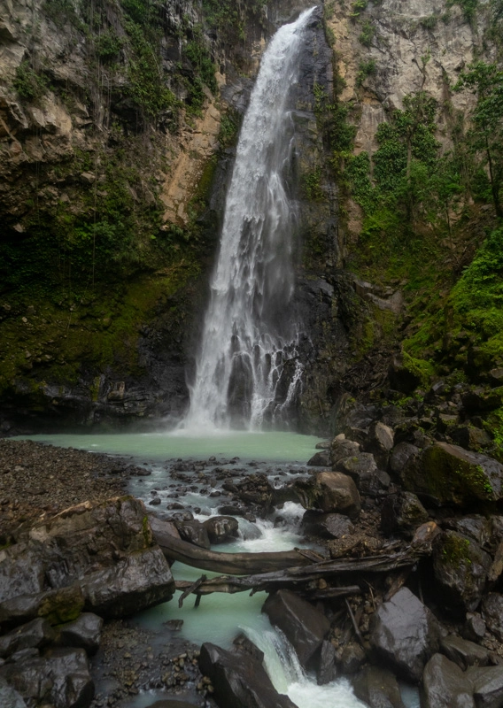 blue water comes down a waterfalls and collects in a pool at victoria falls dominica