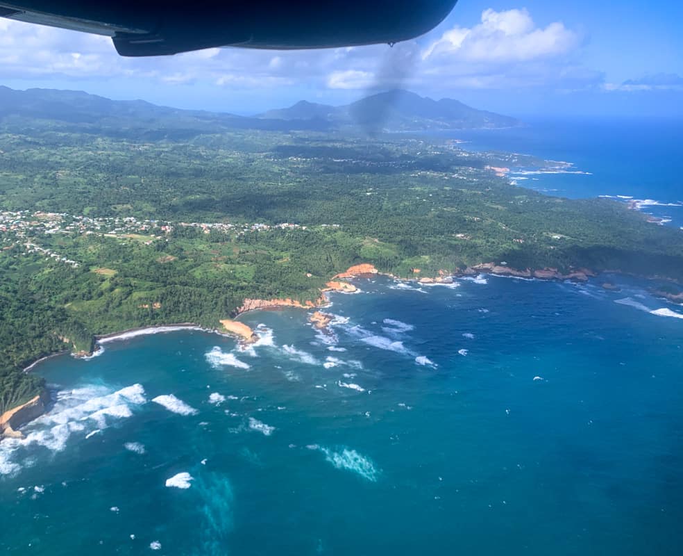 aerial view of the island of dominica from a small plane. you can see the ocean and part of the coastline.