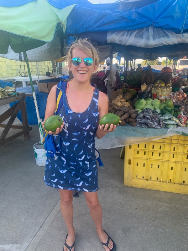 lora buying avocados at the roseau market