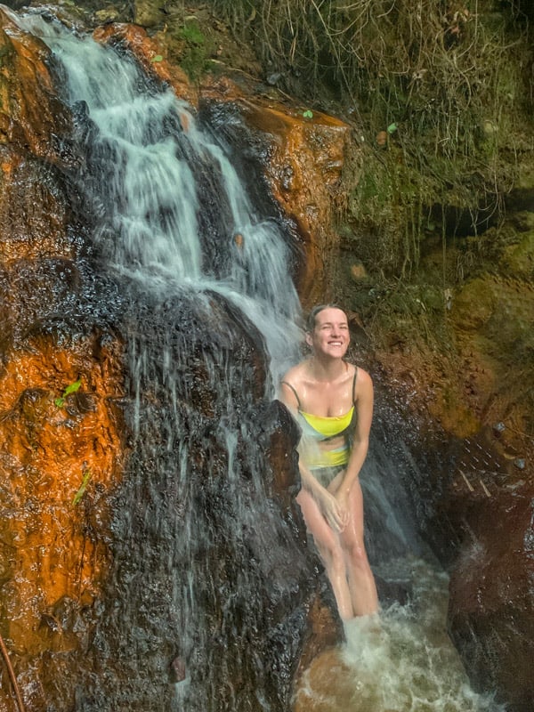 lora under a hot spring waterfall soufriere dominica