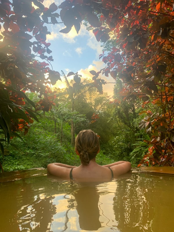 lora in a hot spring in dominica overlooking the lush jungle