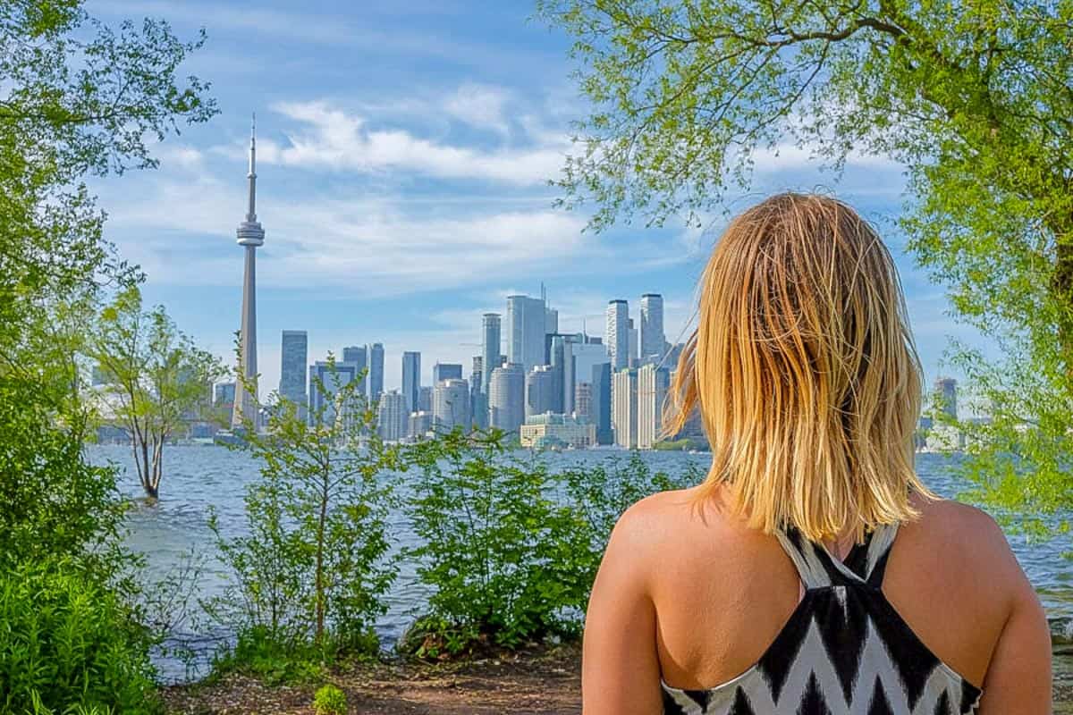 girl looking over at toronto skyline from toronto islands