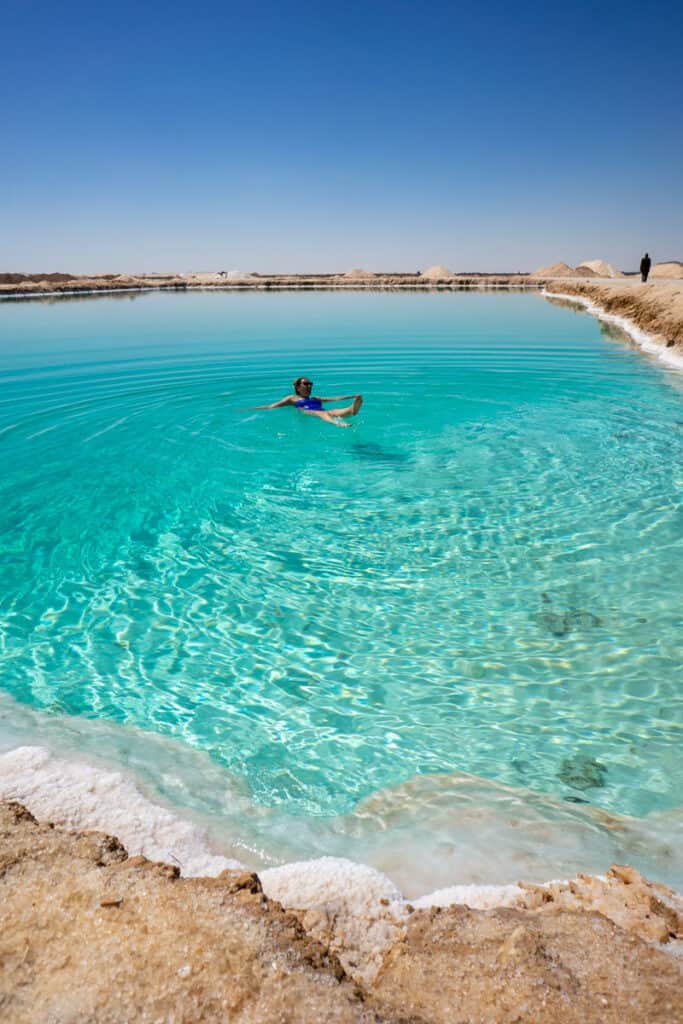 girl swimming in turquoise salt lakes siwa egypt