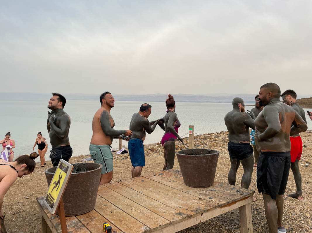 tourists putting on mud at the holiday inn