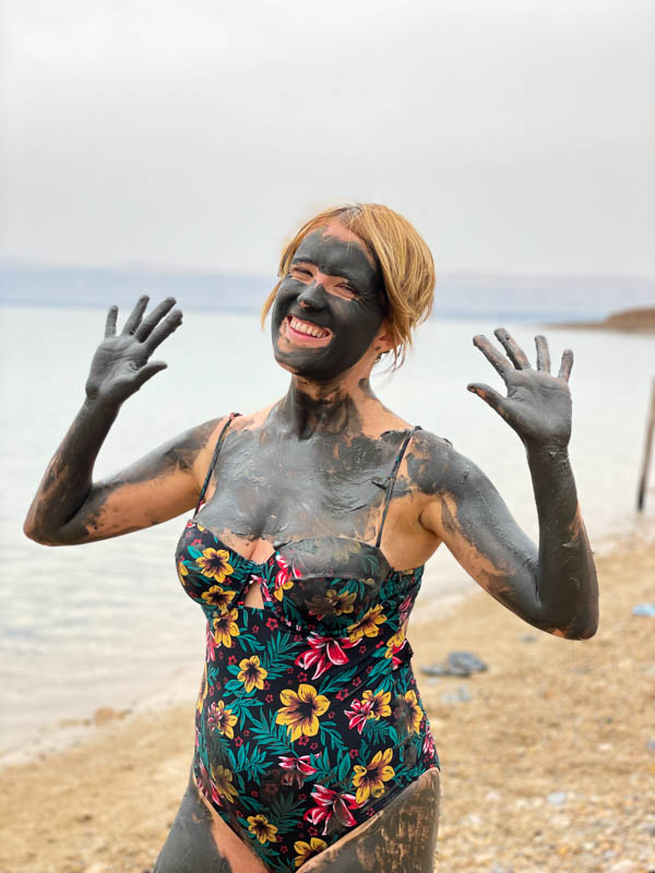 girl covered in mud at the dead sea 