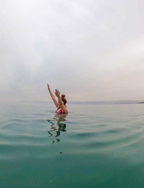 girl floating in the dead sea\