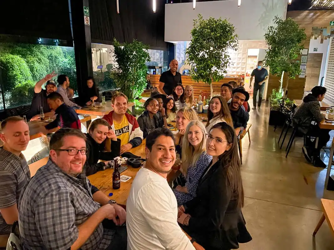 A group of people sitting at a table in one of the best places to live in Mexico.