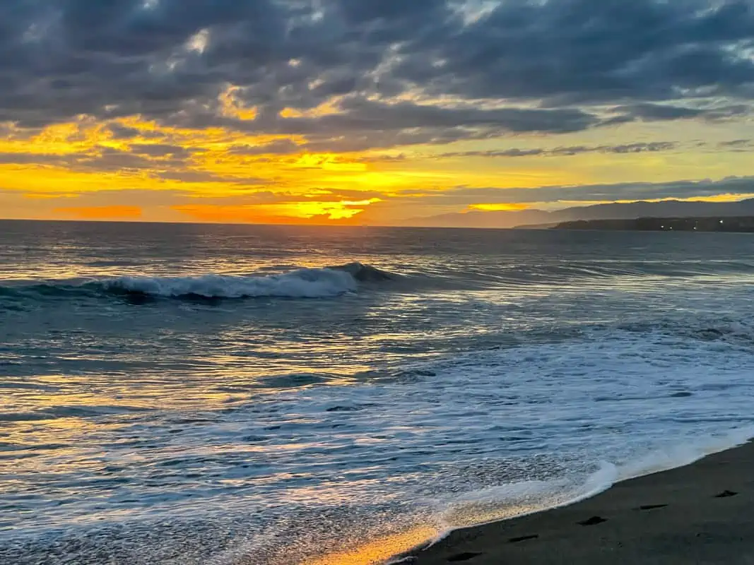 Stunning sunset casting vibrant colors over the beach in Puerto Escondido, Mexico, creating a breathtaking and serene atmosphere