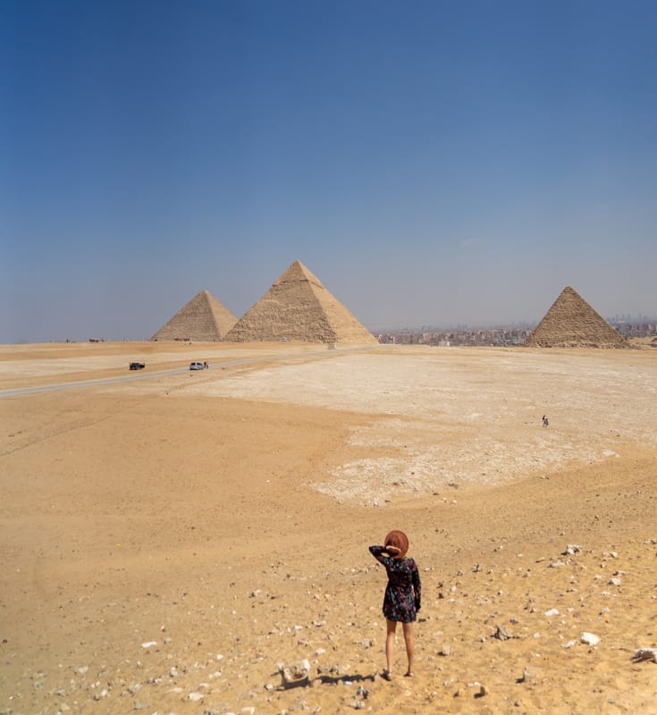 lora standing in front of the great pyramids of giza
