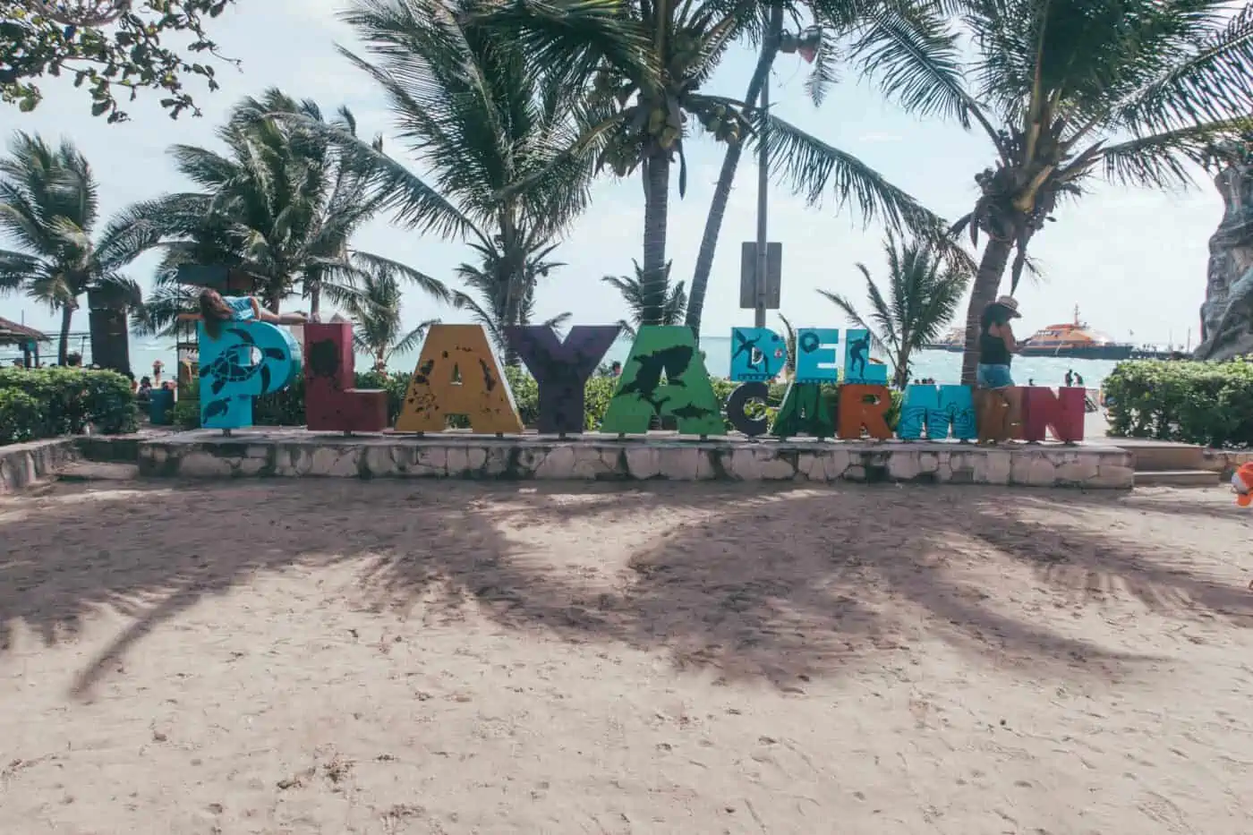 Playa del Carmen sign with a picturesque beach backdrop, inviting visitors to this popular destination in Mexico