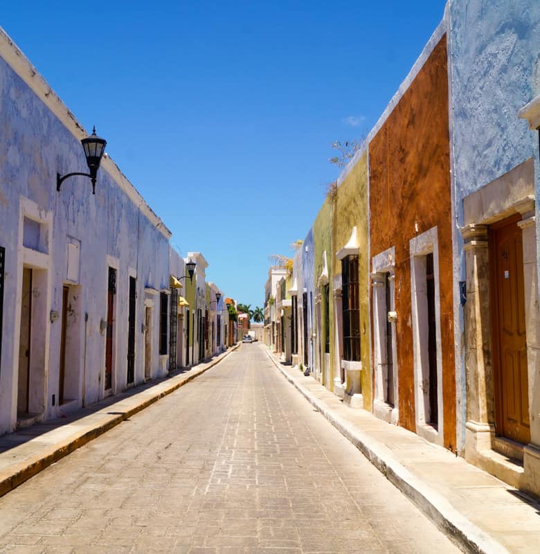 Vibrant and colorful street lined with historic buildings in Campeche, Mexico