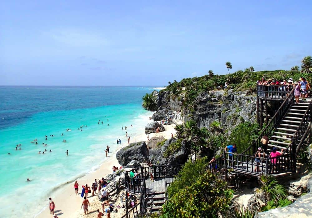 Stunning turquoise water and people enjoying the beautiful beach in Tulum, Mexico
