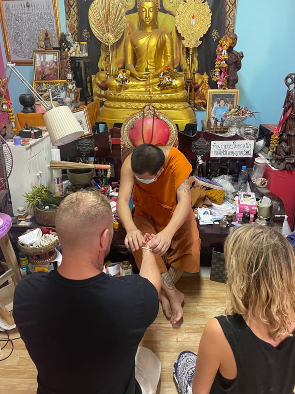 two people being blessed by ajarn in chiang mai