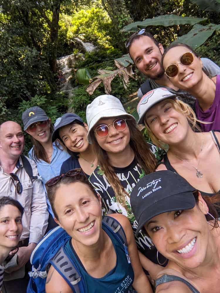 10 friends in chiang mai smiling and looking at the camera from a selfie perspective.