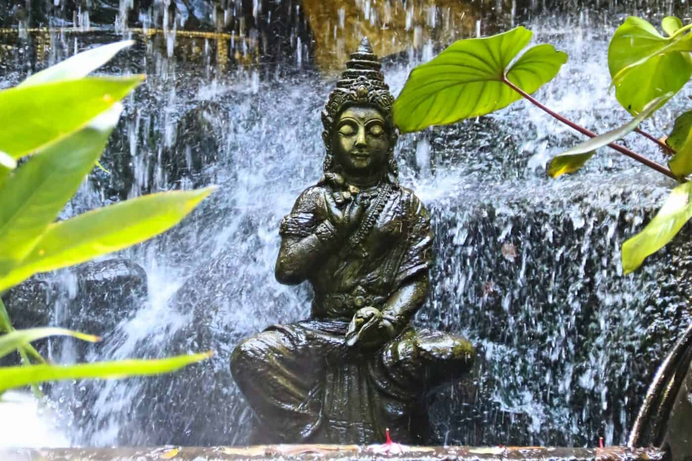 statue under waterfall at Wat Saket 
