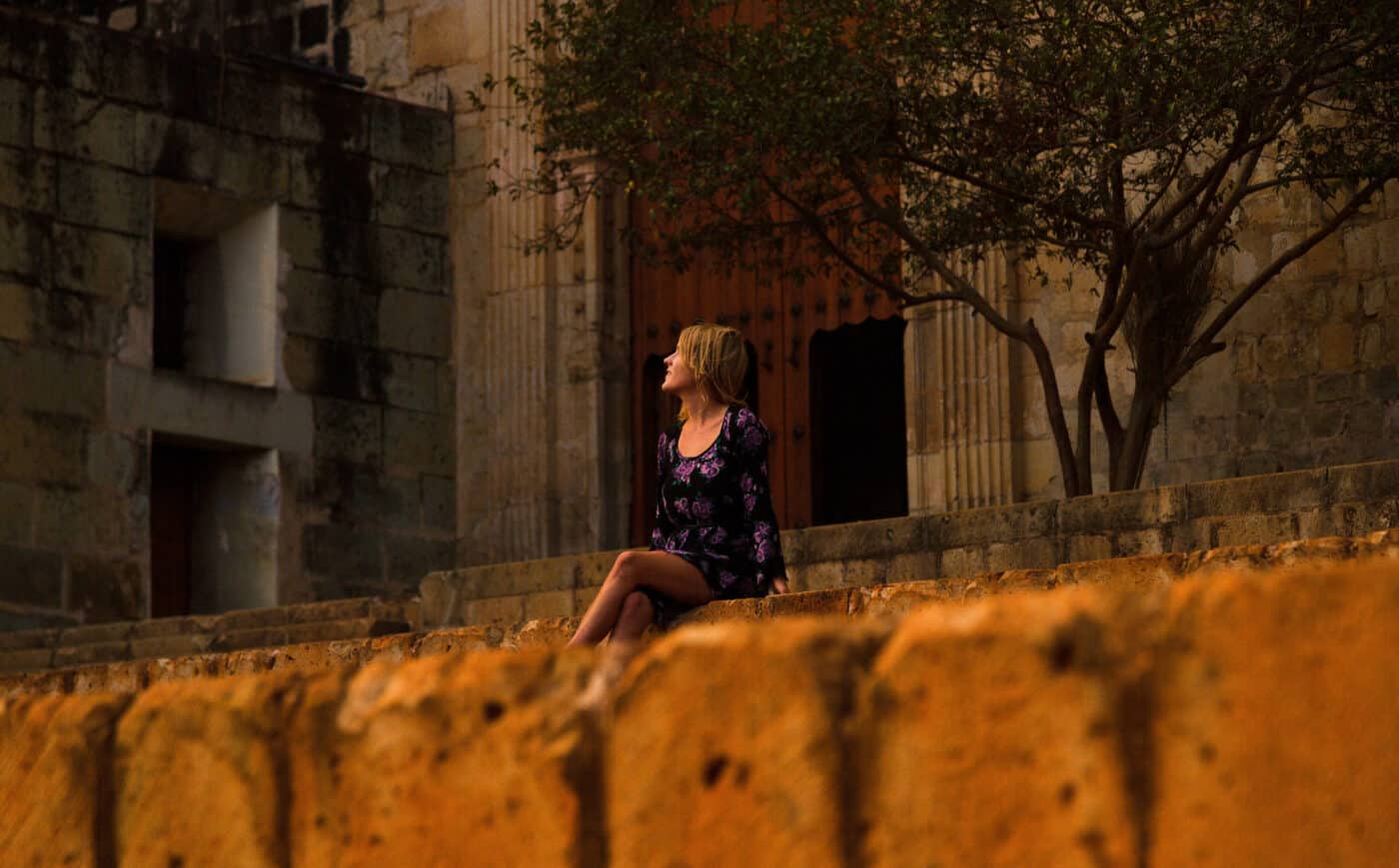 lora sitting by church in oaxaca city