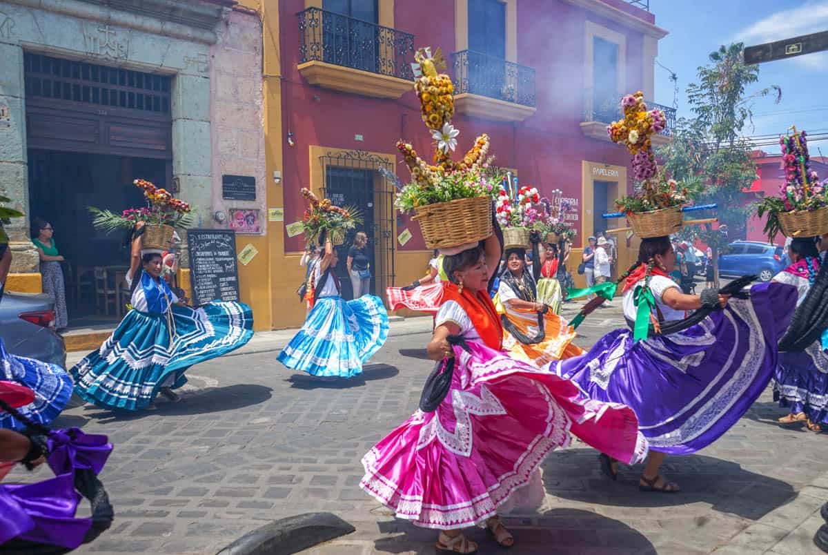 Mexican dancers in colorful skirts on a street in mexico city.