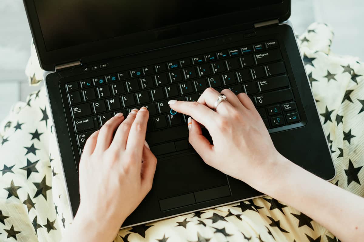 person typing on laptop