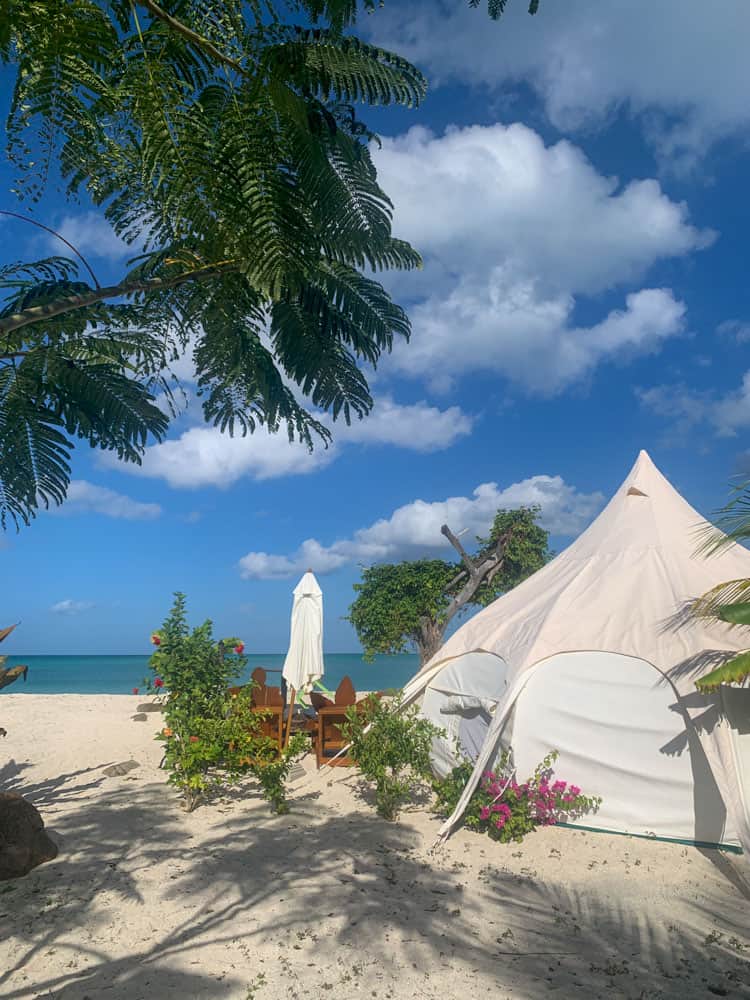 glamping tent on a beach in antigua with ocean in background