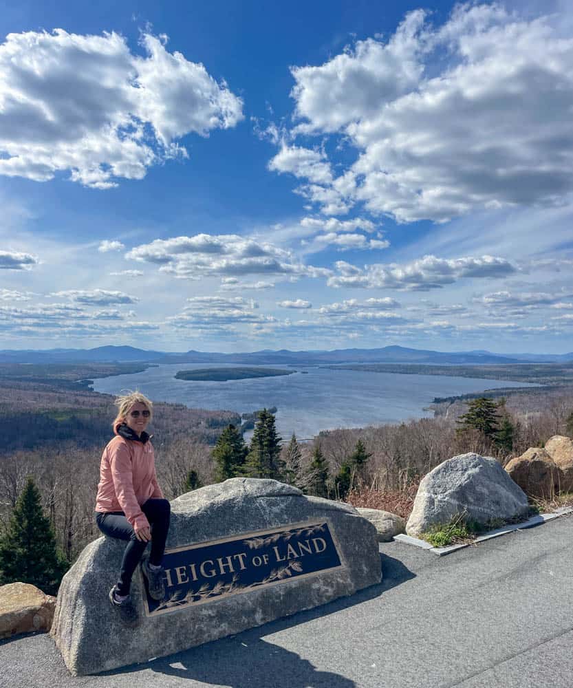 lora sitting on rock at height of lands viewpoint one of the best things to do in rangeley maine