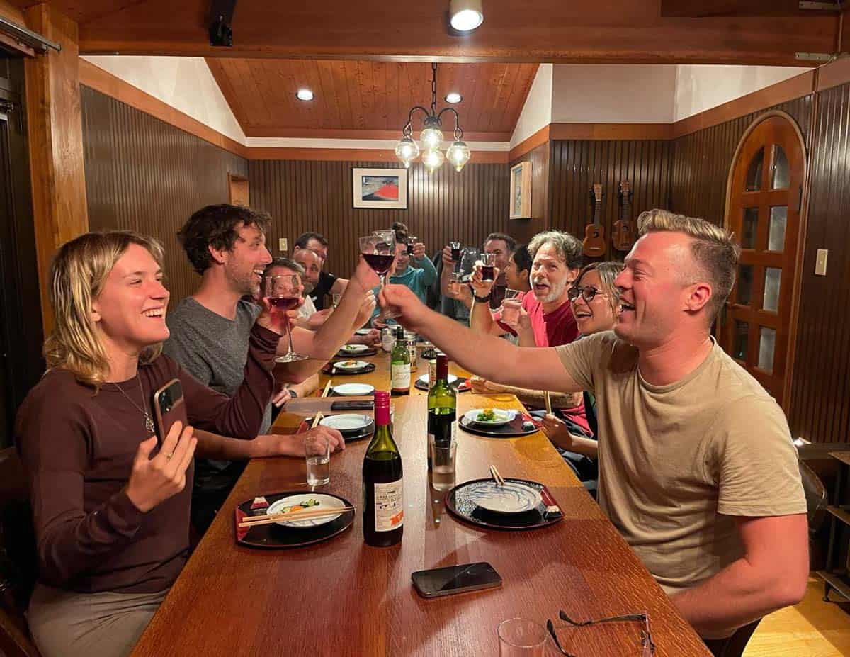A group of people toasting at a long table.