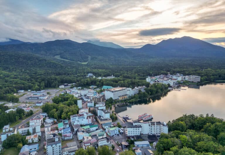 aerial shot of town of lake akan at sunset