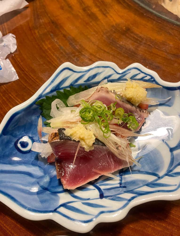 A plate of tuna on a wooden table.