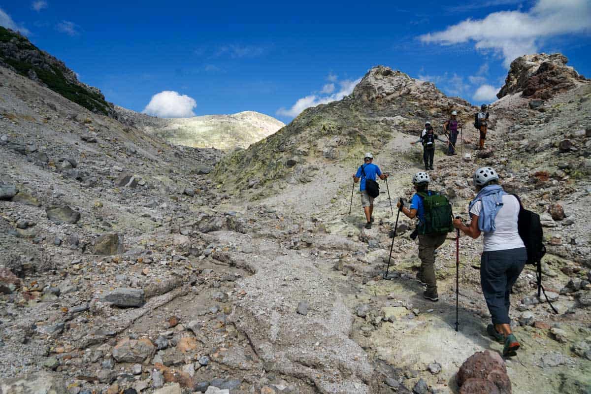 A group of people hiking up a rocky mountain.
